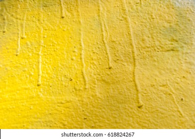 Closeup Of Yellow Graffiti On The Wall Texture