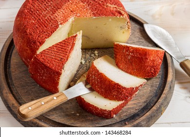 Closeup of yellow hard cheese with red wax - Powered by Shutterstock