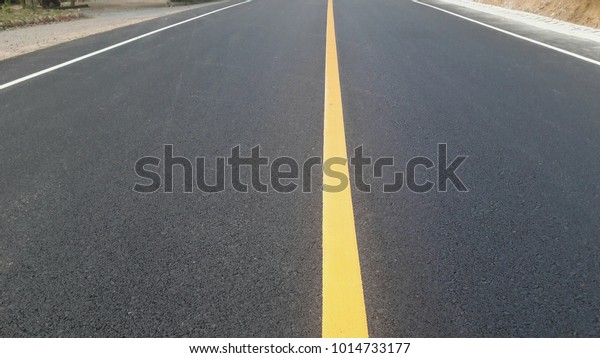 closeup yellow\
line asphalt road empty\
background