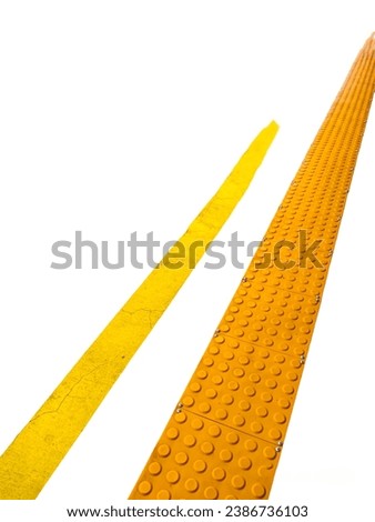 Close-up of yellow lines and textured yellow blocks at train stations as guiding blocks or blind road sidewalks for normal passengers and passengers with disabilities isolated on white background