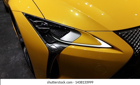 Closeup yellow super car head light,