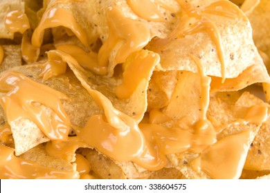 Close-up Of Yellow Tortilla Chips Covered In Nacho Cheese