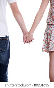 Closeup Of Young Affectionate Couple Holding Hands Over White Background.