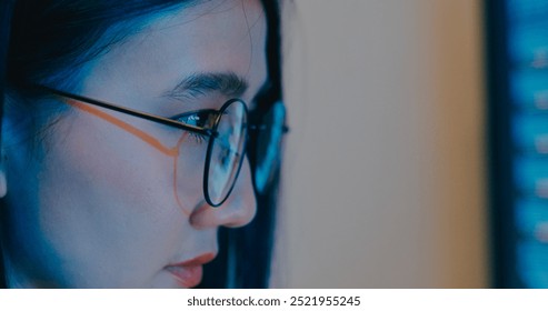 Closeup young Asia female freelance eyeglasses typing write prompt AI bot IT program nomad, video game, terminal with coding language, designer, big data center on desktop computer in night office.