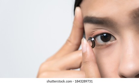 Close-up Young Asian Woman Wearing Contact Lens.