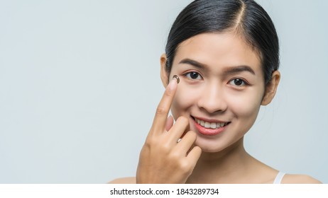 Close-up Young Asian Woman Wearing Contact Lens, Look At Camera.