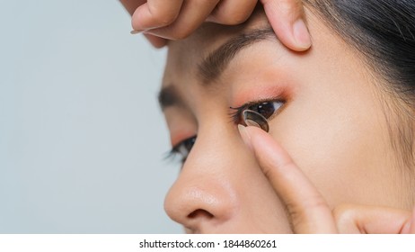 Close-up Young Asian Woman Wearing Contact Lens, Macro Shot.