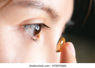 Close-up Of Young Asian Woman Wearing Contact Lens.