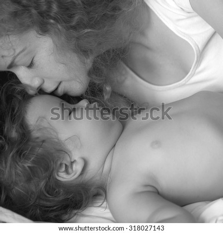 Similar – Young woman caressing man face lying over bed