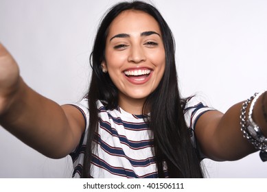 Close-up of young beautiful woman taking selfie. Isolated white background - Shutterstock ID 401506111