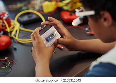 Closeup Of Young Black Boy Building Robots In Engineering Class At School, Copy Space