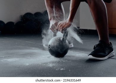 Close-up Of Young Black Man Doing Kettlebell Squats With Chalk At The Gym