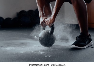 Close-up of young black man doing kettlebell squats at the gym - Powered by Shutterstock