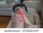 Closeup young boy feeling pain in his knee after play at home. Healthcare and medical concept.