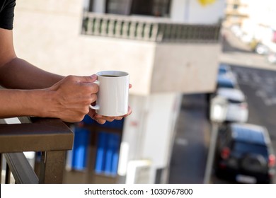 closeup of a young caucasian man having a coffee in the balcony of his home or of a hotel - Powered by Shutterstock