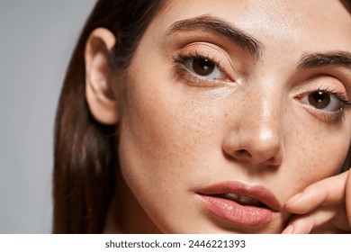 A close-up of a young Caucasian woman with mesmerizing brown eyes and clean skin in a studio setting. - Powered by Shutterstock