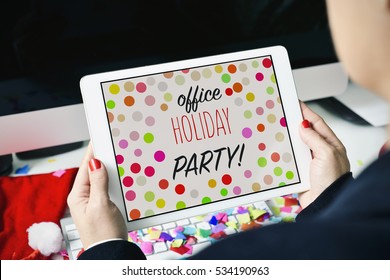 Closeup Of A Young Caucasian Woman Sitting At Her Office Desk Full Of Confetti Looking To Her Tablet, With The Text Office Holiday Party In Its Screen