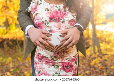 Closeup of young couple's hands on pregnant belly - Powered by Shutterstock