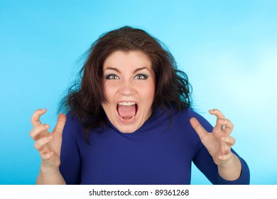 Closeup Of The Young Crazy Crying Woman On The Blue Background