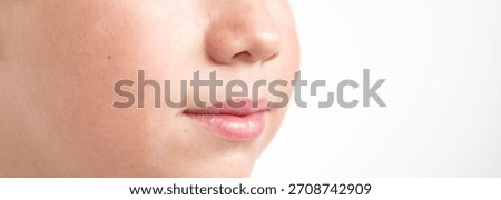 Close-up young boy’s face, soft contours of his jaw and neck, smooth skin with natural texture, soft lips, neutral expression, white background, studio lighting, teenage life, difficult age