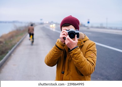 Closeup Of Young Hipster Man With Digital Camera Outdoors. Young Male Photographer Photographing Nature