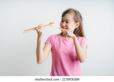 Close-up. young lady eating sushi roll - Shutterstock ID 2178930389