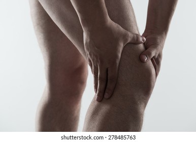 Closeup of young male massaging his sore knee. Joint disease treatment.  - Shutterstock ID 278485763