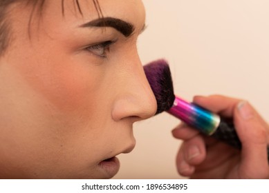 Close-up Of A Young Man Applying Makeup With Brush