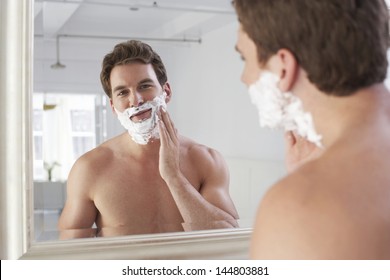 Closeup Of A Young Man Applying Shaving Cream