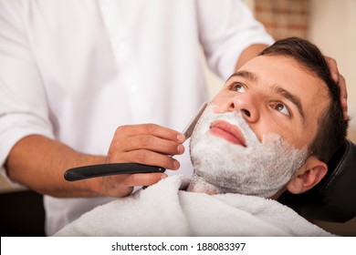 Closeup Of A Young Man Getting A Close Shave At A Barber Shop