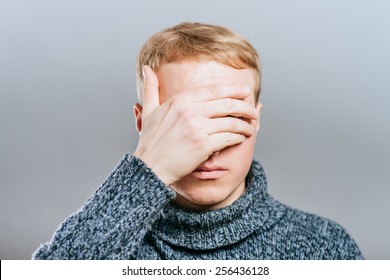 Closeup Of Young Man Hiding Face Whit Hands