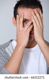 Closeup Of Young Man Hiding Face Whit Hands