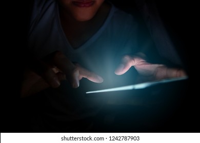 Close-up young man sitting on the bed using smartphone at late night, Phone disease and Nomophobia. Healthy Concept - Powered by Shutterstock