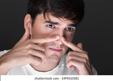 Close-up Young Man Touching Nose