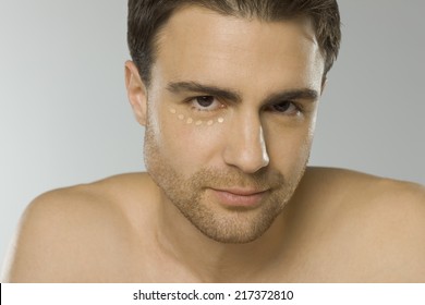 Close-up Of Young Man Using Eye Cream, Portrait