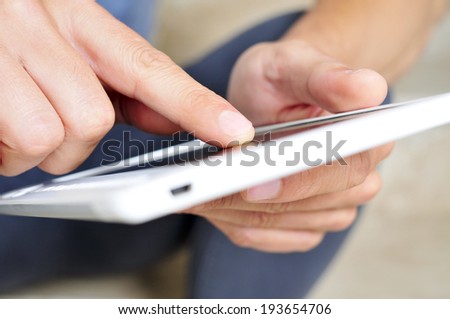 closeup of a young man using a tablet computer