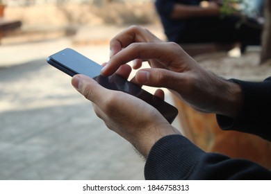 Closeup Of Young Man's Hand Using Android Phone