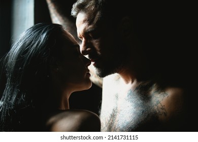 Close-up of young romantic couple is kissing each other. Sexy elegant couple lovers in the tender passion. Portrait of lovely sexy couple in love. Man kiss sensual woman. Romantic couples embraces.