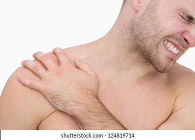 Close-up Of Young Shirtless Man With Shoulder Pain Over White Background