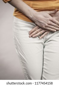 Closeup young sick woman with hands holding pressing her crotch lower abdomen. Medical or gynecological problems, healthcare concept - Shutterstock ID 1177454158