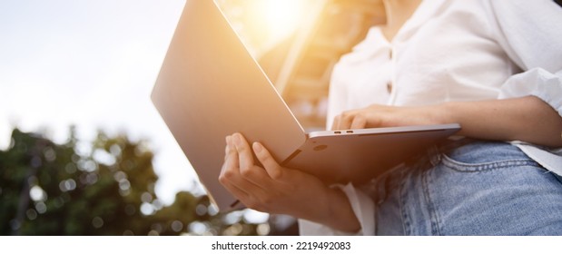 Close-up Of A Young Woman In The City Using A Laptop Computer Outside The House.