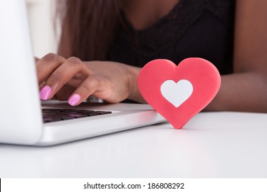 Close-up Of Young Woman Dating Online On Laptop At Home