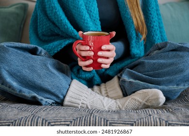 Close-up of young woman hands holding winter mug with hot drink - Powered by Shutterstock