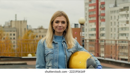 Close-up of Young Woman holding Open Face Golden Motorcycle Helmet Before Riding a Bike - Shutterstock ID 2221956169
