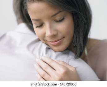 Closeup Of A Young Woman Hugging A Man