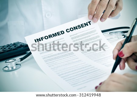 closeup of a young woman patient signing an informed consent at the doctors office