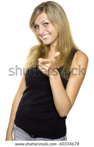 Close-up of young woman pointing at camera. Isolated on white background