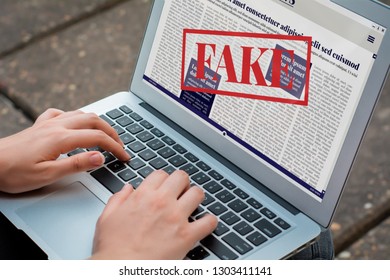 Closeup Of Young Woman Reading Digital Fake News On Laptop. Propaganda And Disinformation Online. Media And Digital Concept. All Screen Graphics Are Made Up By Us