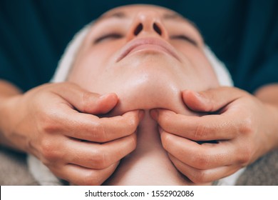 Close-up Of A Young Woman Receiving Chin And Jawline Face Lifting Massage