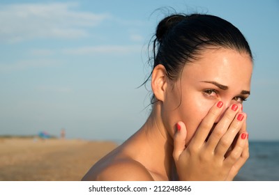 Close-up Of A Young Woman With Red Eye  Rubbing  Irritated Sensitive Eyes Or Nose On The Beach, Allergy Reaction